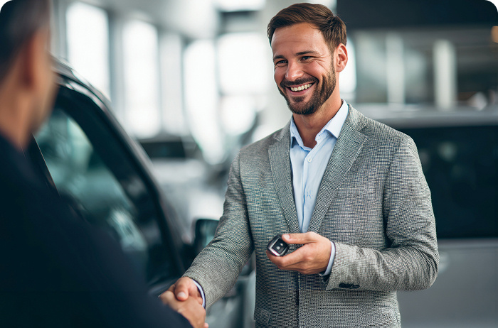 A person handing a car key to another person